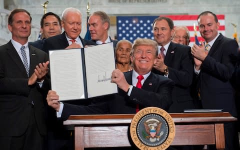  President Donald Trump signs a Presidential Proclamation shrinking Bears Ears and Grand Staircase-Escalante national monuments at the Utah State Capitol in Salt Lake City - Credit: AFP