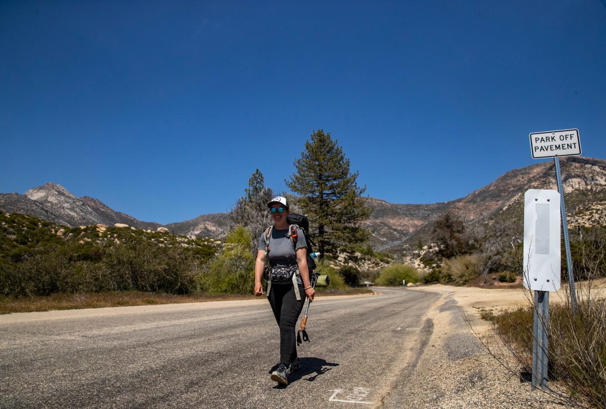 PCT hiker Coline Andre continues down the road on her way to Idyllwild after getting off Spitler Peak Trail in Mountain Center, Calif., Thursday, May 11, 2023. 