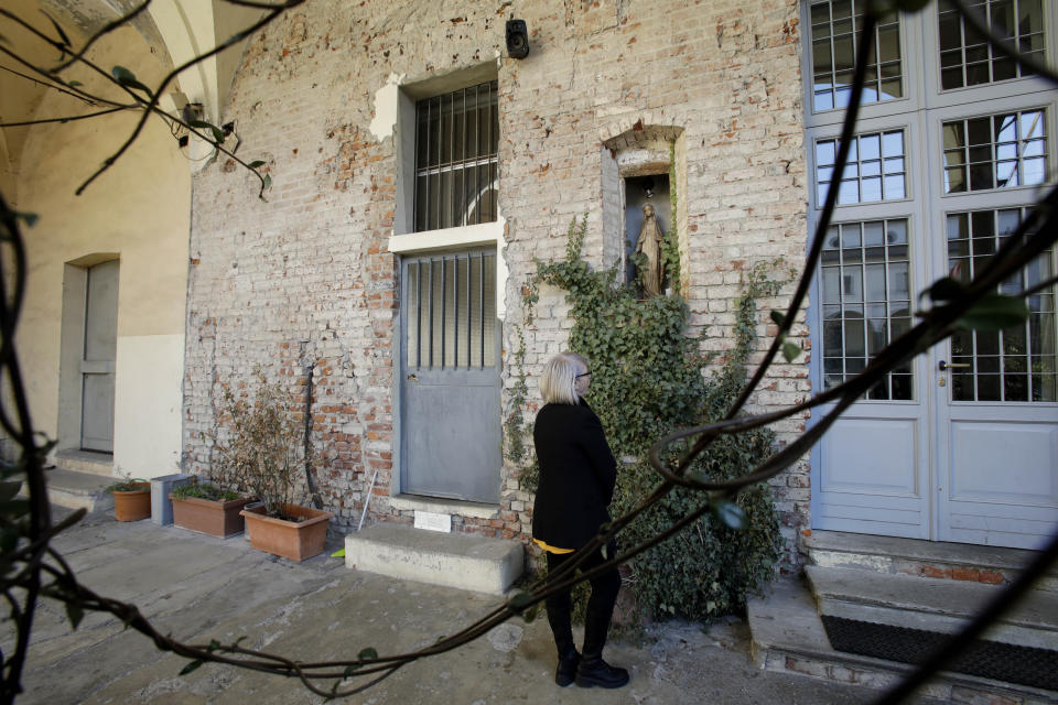 In this picture taken on Friday, Jan. 31, 2020 Yolanda Martinez Garcia stands in front of a Holy Madonna statue, at the Sant'Eustorgio's oratory church, in Milan, Italy. Her son was sexually abused by one of the priests of the Legion of Christ, a disgraced religious order. (AP Photo/Luca Bruno)