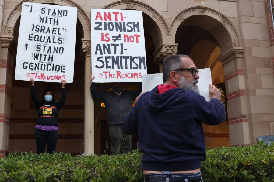 Los Angeles, CA – April 25: David Moritz holds a sign stating, “Anti-Zionism is Genocidal Anti-Semitism,” in front of pro-Palestine protestors during a pro-Palestine protest that has students in an encampment outside outside of Royce Hall at UCLA on Thursday, April 25, 2024 in Los Angeles, CA. (Michael Blackshire / Los Angeles Times via Getty Images)