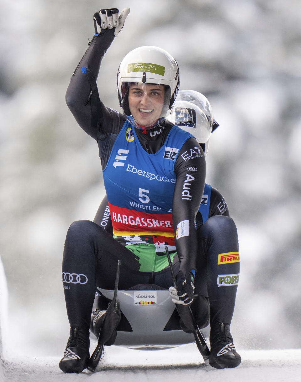 Gold medalists Andrea Votter and Marion Oberhofer, of Italy, celebrate during the luge World Cup in Whistler, British Columbia, Saturday, Dec. 10, 2022. (Jonathan Hayward/The Canadian Press via AP)