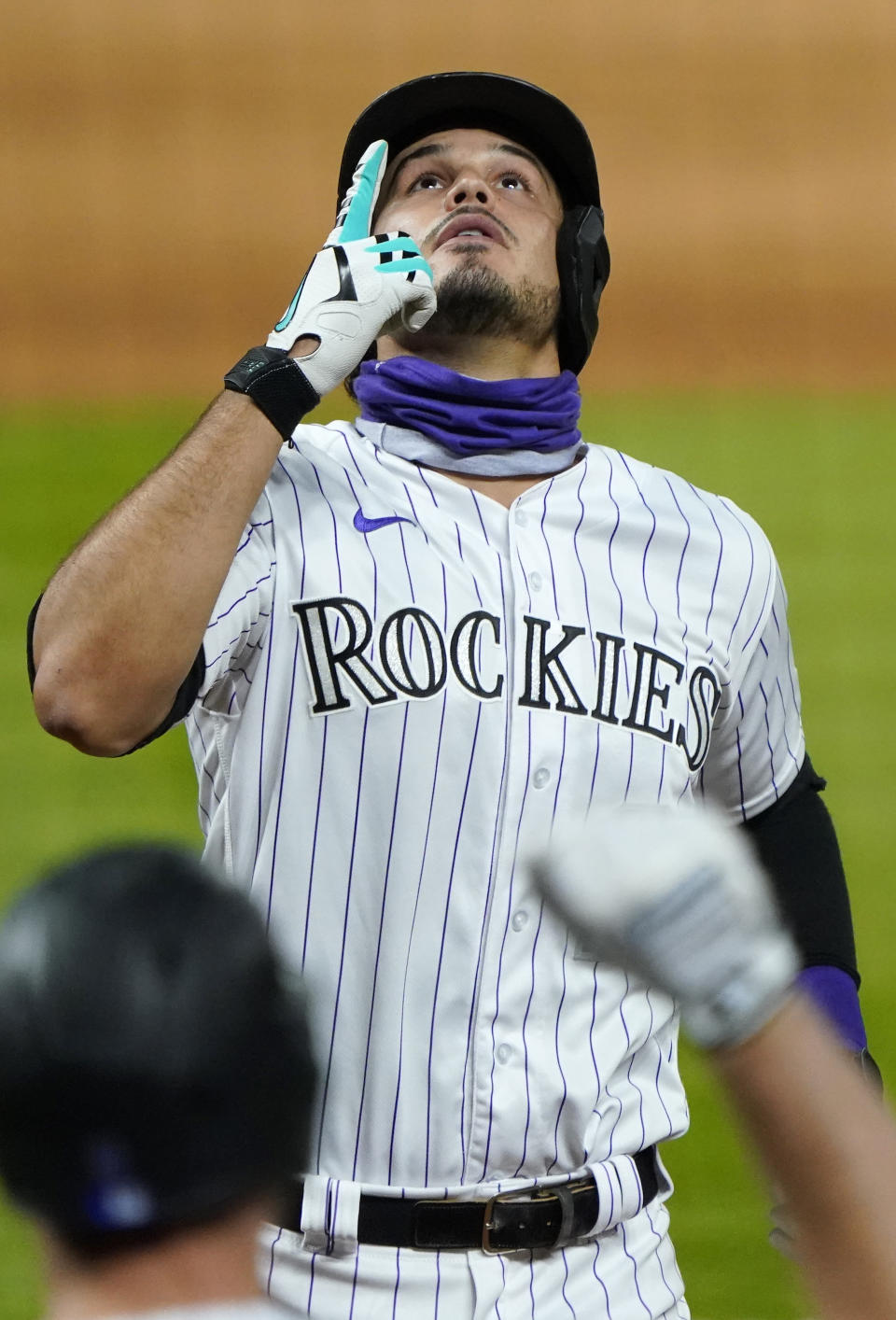 Colorado Rockies' Nolan Arenado points skyward as he celebrates a two-run home run against the San Francisco Giants during the sixth inning of a baseball game Monday Aug. 3, 2020, in Denver. (AP Photo/Jack Dempsey)