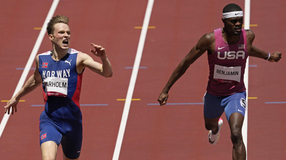 Karsten Warholm, of Norway celebrates as he wins the gold medal ahead of Rai Benjamin, of United States in the final of the men's 400-meter hurdles at the 2020 Summer Olympics, Tuesday, Aug. 3, 2021, in Tokyo, Japan. (AP Photo/Charlie Riedel)