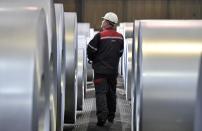 FILE - In this April 27, 2018 file photo, a worker controls steel coils at the thyssenkrupp steel factory in Duisburg, Germany. The European Union and the United States have decided to temporarily suspend measures at the heart of a steel tariff dispute that is seen as one of the major trade issues dividing the two sides. The issue goes back to the 2018 tariffs that then-President Donald Trump slapped on EU steel and aluminum, which enraged Europeans and other allies by calling their metals a threat to U.S. national security. (AP Photo/Martin Meissner, File)