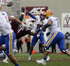 Pittsburgh quarterback Kenny Pickett (8) passes while pressured by Virginia Tech defensive lineman Amare Barno (11) in the first half of an NCAA college football game, Saturday, Oct. 16 2021, in Blacksburg, Va. (Matt Gentry/The Roanoke Times via AP)