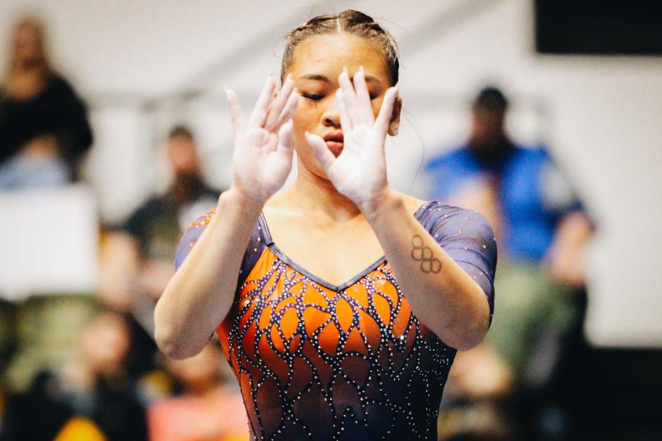 Auburn's Sunisa Lee focuses as she performs her balance beam routine during a college gymnastics meet against the University of Missouri on Feb. 19, 2023, at the Hearnes Center in Columbia, Mo.