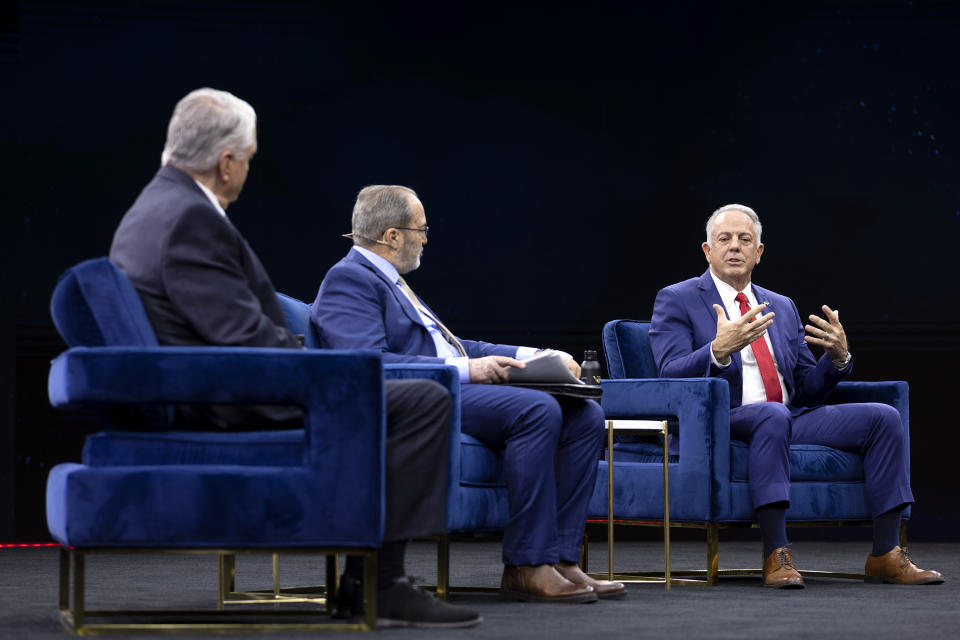 Nevada Republican gubernatorial nominee Joe Lombardo, right, answers questions in debate with Gov. Steve Sisolak, left, D-Nev., moderated by The Nevada Independent CEO Jon Ralston, center, during IndyFest at Worre Studios, Sunday, Oct. 2, 2022, in Las Vegas. (AP Photo/Ellen Schmidt)