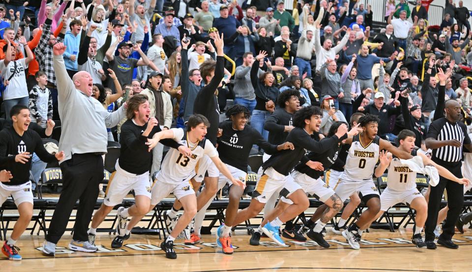 The College of Wooster bench runs onto the court to mob teammate Tanner Kurt after his game-winning 3.