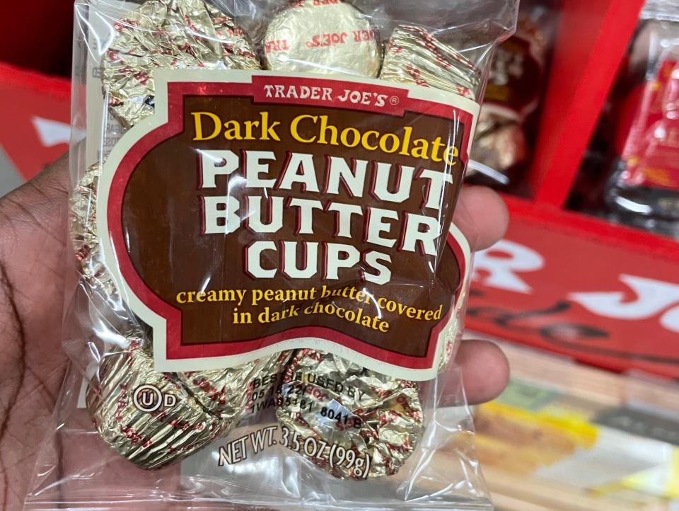 hand holding trader joes dark chocolate peanut butter cups