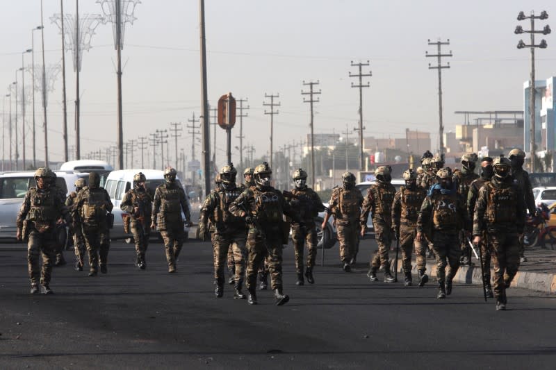 Iraqi security forces are seen during ongoing anti-government protests in Basra