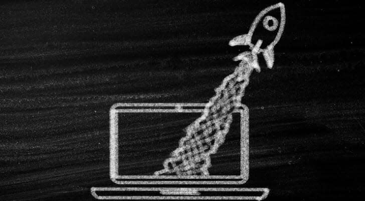 Chalk drawing of a rocket taking off from a PC