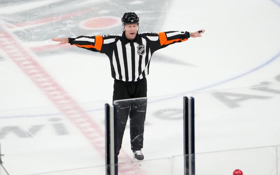 Referee Brad Meier waves off a goal by Columbus Blue Jackets defenseman Zach Werenski for being offsides during the second period of the NHL hockey game Anaheim Ducks at Nationwide Arena in Columbus on Thursday, Dec. 9, 2021.