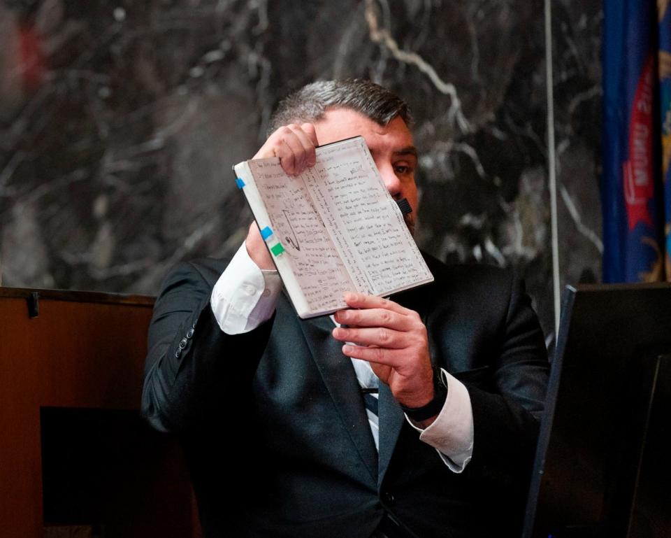 PHOTO: Oakland County Sheriff Lt. Timothy Willis holds up Ethan Crumbley's journal so the jury can see it as Jennifer Crumbley sits at Oxford High School in the Oakland County courtroom, Feb. 1, 2024 in Pontiac, Mich. (Mandi Wright/Detroit Free Press via AP)