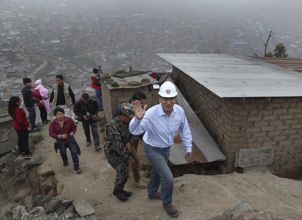 In this Sept. 27, 2018 photo, Peru's President Martin Vizcarra waves to reporters during a visit to the Flor de Amancaes shantytown in Lima, Peru. Vizcarra's sudden rise from little-known vice president to popular chief of state is in fact an ascent he spent years preparing for while serving as governor of one of Peru's most sparsely populated regions. "How do you make big decisions?" he said. "By first being tested at a small scale."(AP Photo/Martin Mejia)