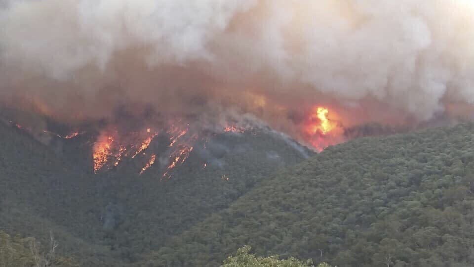 In this image released Thursday, Jan. 2, 2020, from the Department of Environment, Land, Water and Planning in Gippsland, Australia, smoke rises from wildfires burning in East Gippsland, Victoria. Thousands of tourists are fleeing Australia's wildfire-ravaged eastern coast ahead of worsening conditions as the military started to evacuate people trapped on the shore further south. Cooler weather has aided firefighting and allowed people to replenish supplies. (DELWP Gippsland via AP)