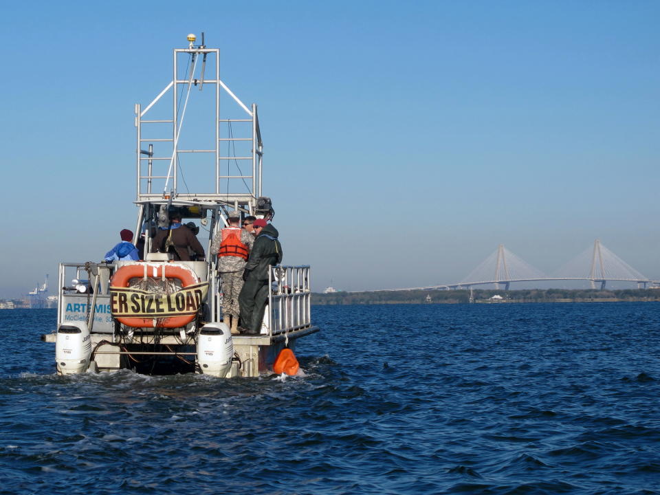 A boat moves into position in the harbor in Charleston, S.C., on Friday, Nov. 9, 2012, so it can take sediment samples of the harbor floor. The samples are required for a study of a $300 million deepening of the harbor shipping channel so it can handle larger container ships. (AP Photo/Bruce Smith)