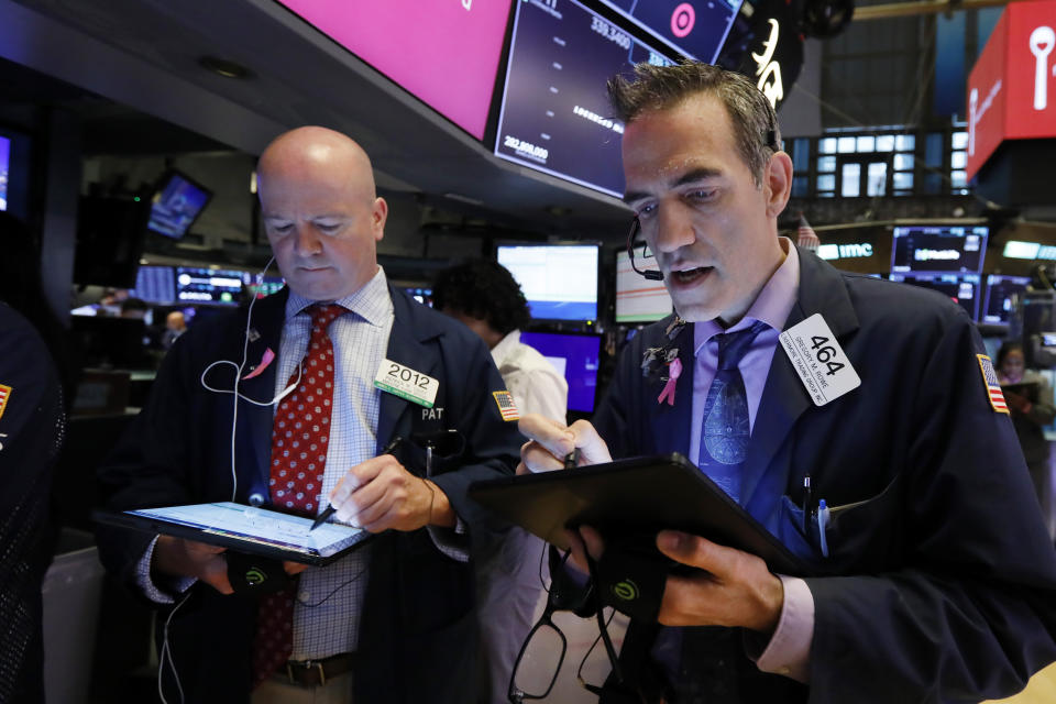 Traders Patrick Casey, left, and Gregory Rowe work on the floor of the New York Stock Exchange, Thursday, May 30, 2019. Stocks are edging higher in early trading on Wall Street following two days of losses. (AP Photo/Richard Drew)