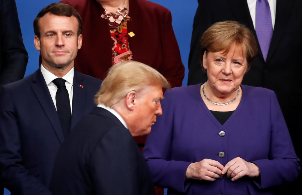 France's President Emmanuel Macron and Germany's Chancellor Angela Merkel look at U.S. President Donald Trump during a family photo opportunity at the NATO leaders summit in Watford, Britain December 4, 2019. REUTERS/Christian Hartmann/Pool