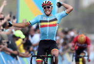 <p>Greg Van Avermaet of Belgium celebrates winning the gold medal in the men’s cycling road race on August 6, 2016. (Reuters/Bryn Lennon/Pool) </p>