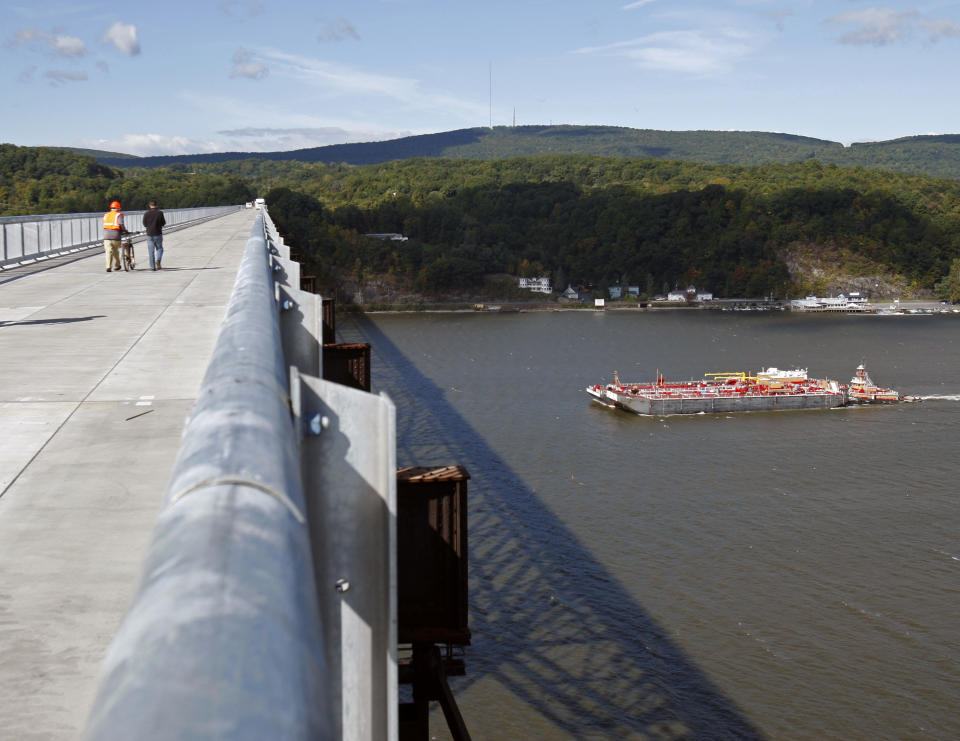 FILE - This Sept. 25, 2009 file photo shows a barge cruising under the Walkway Over the Hudson bridge in Poughkeepsie, N.Y. Some of the best views of the Hudson River are from a rail bridge-turned-pedestrian walkway 212 feet above the water. The popular Walkway Over the Hudson spans 1.25 miles between Highland and Poughkeepsie. (AP Photo/Mike Groll, File)