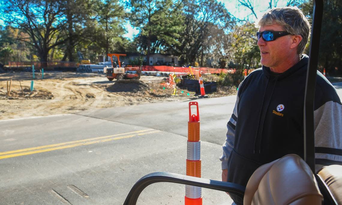 Hilton Head Island resident Daniel Anthony stands along Jonesville Road near a recently patched road on Friday, Jan. 6, 2023 with some of the property under development visible to the left. Anthony said the construction team dug up the entire road at once which shut down access to his neighborhood for several hours.