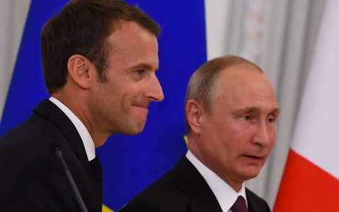 Vladimir Putin appears at a press conference with Emmanuel Macron on Thursday. The two will speak at Russia's St Petersburg economic forum on Friday - Credit: Kirill Kudryavtsev/AFP/Getty Images