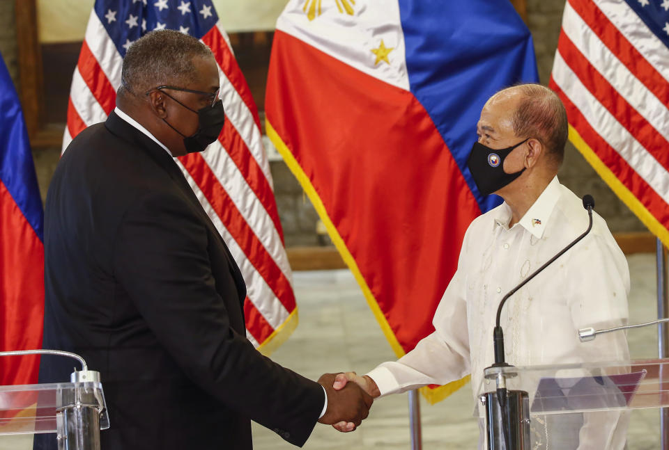 United States Defense Secretary Lloyd Austin, left, and Philippines Defense Secretary Delfin Lorenzana shake hands after a bilateral meeting at Camp Aguinaldo military camp in Quezon City, Metro Manila, Philippines Friday, July 30, 2021. Austin is visiting Manila to hold talks with Philippine officials to boost defense ties and possibly discuss the The Visiting Forces Agreement between the US and Philippines. (Rolex dela Pena/Pool Photo via AP)