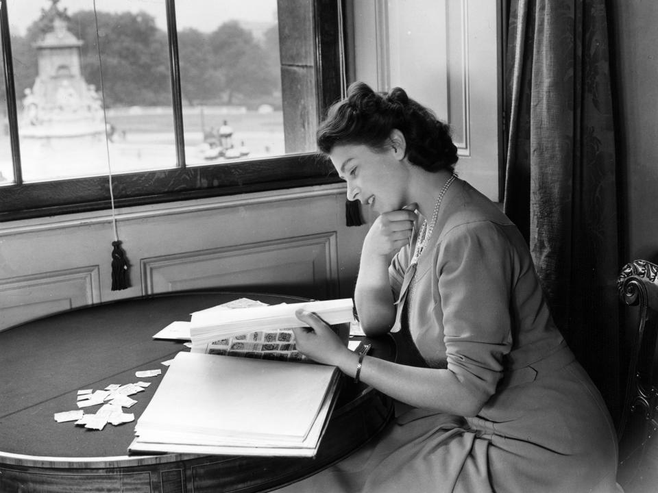 Queen Elizabeth looks through her stamp collection in 1946