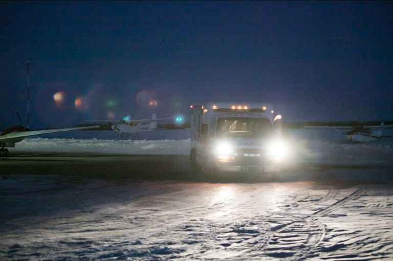 An emergency vehicle is seen near the crash site on April 6, 2018 after a bus carrying a junior ice hockey team collided with a semi-trailer truck between Tisdale and Nipawin, Saskatchewan province, killing 14 people