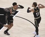 Atlanta Hawks forward John Collins (20) and guard Trae Young (11) flex at each other after teaming up for a score against the Oklahoma City Thunder in an NBA basketball game Thursday, March 18, 2021, in Atlanta. (Curtis Compton/Atlanta Journal-Constitution via AP)