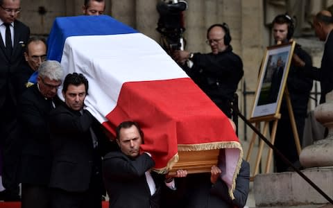 The coffin of former French President Jacques Chirac, covered with the French national flag, is carried by pall bearers as it leaves the Saint-Sulpice church - Credit: &nbsp;MARTIN BUREAU/AFP