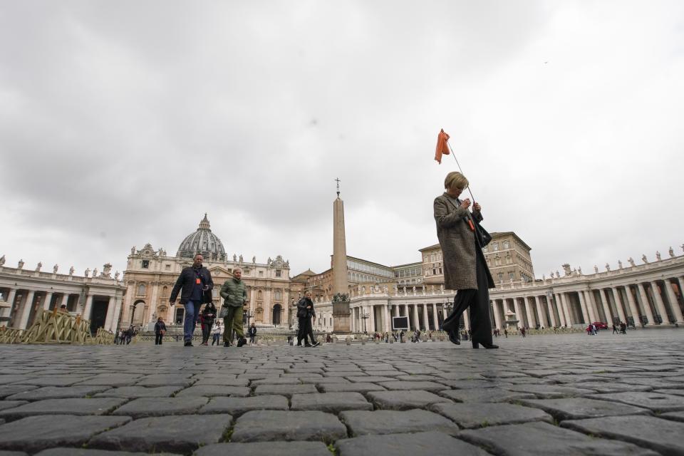 People walk in St. Peter's Square at the Vatican, Friday, March 6, 2020. A Vatican spokesman has confirmed the first case of coronavirus at the city-state. Vatican spokesman Matteo Bruni said Friday that non-emergency medical services at the Vatican have been closed so they can be sanitized following the positive test on Thursday. (AP Photo/Andrew Medichini)