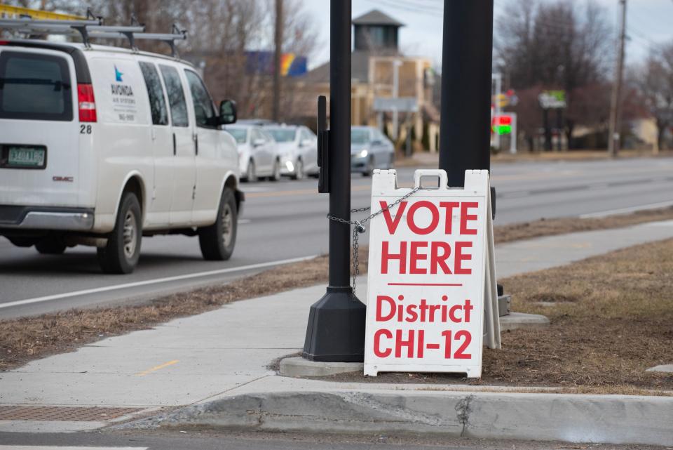 A sign on Shelburne Road at the entrance of Baldwin Avenue shows the way to the Orchard School polling station in South Burlington on Town Meeting Day, Tuesday, March 5, 2024.