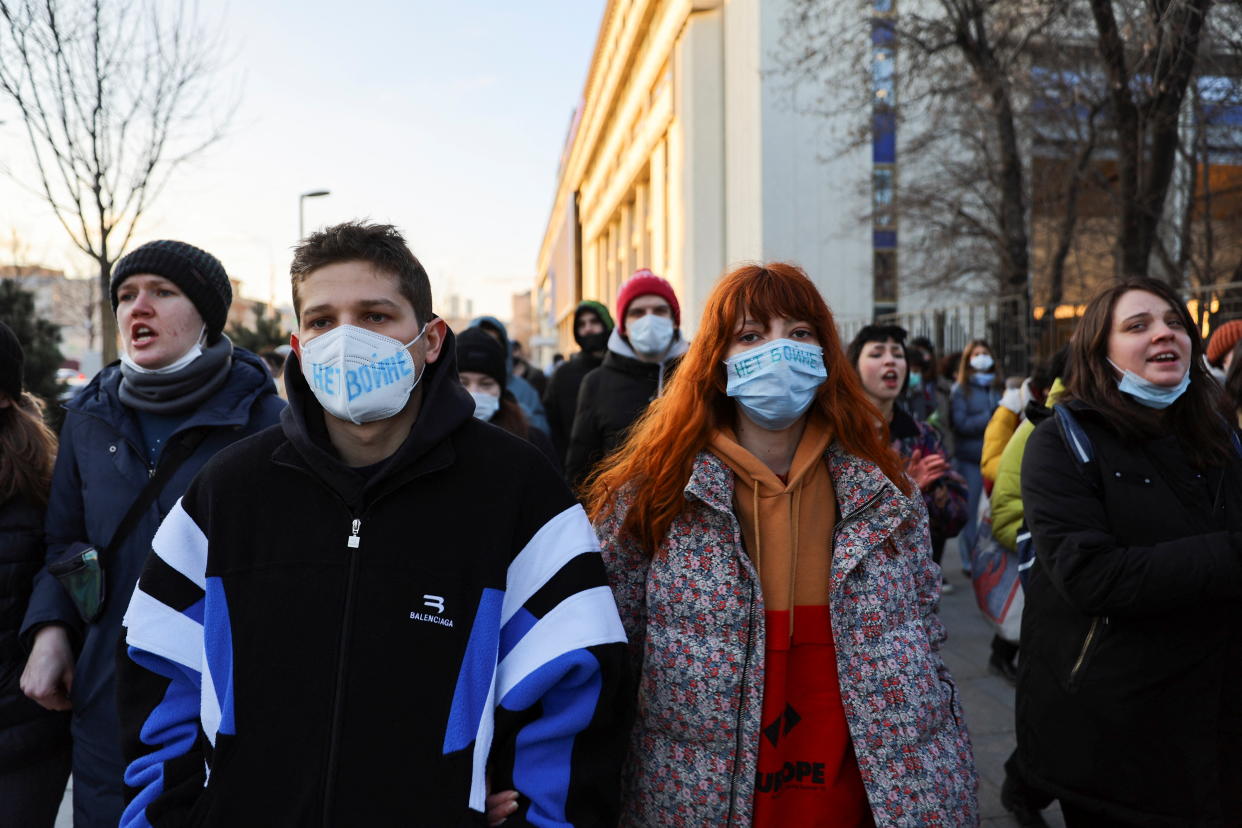 People wearing masks with the slogan 