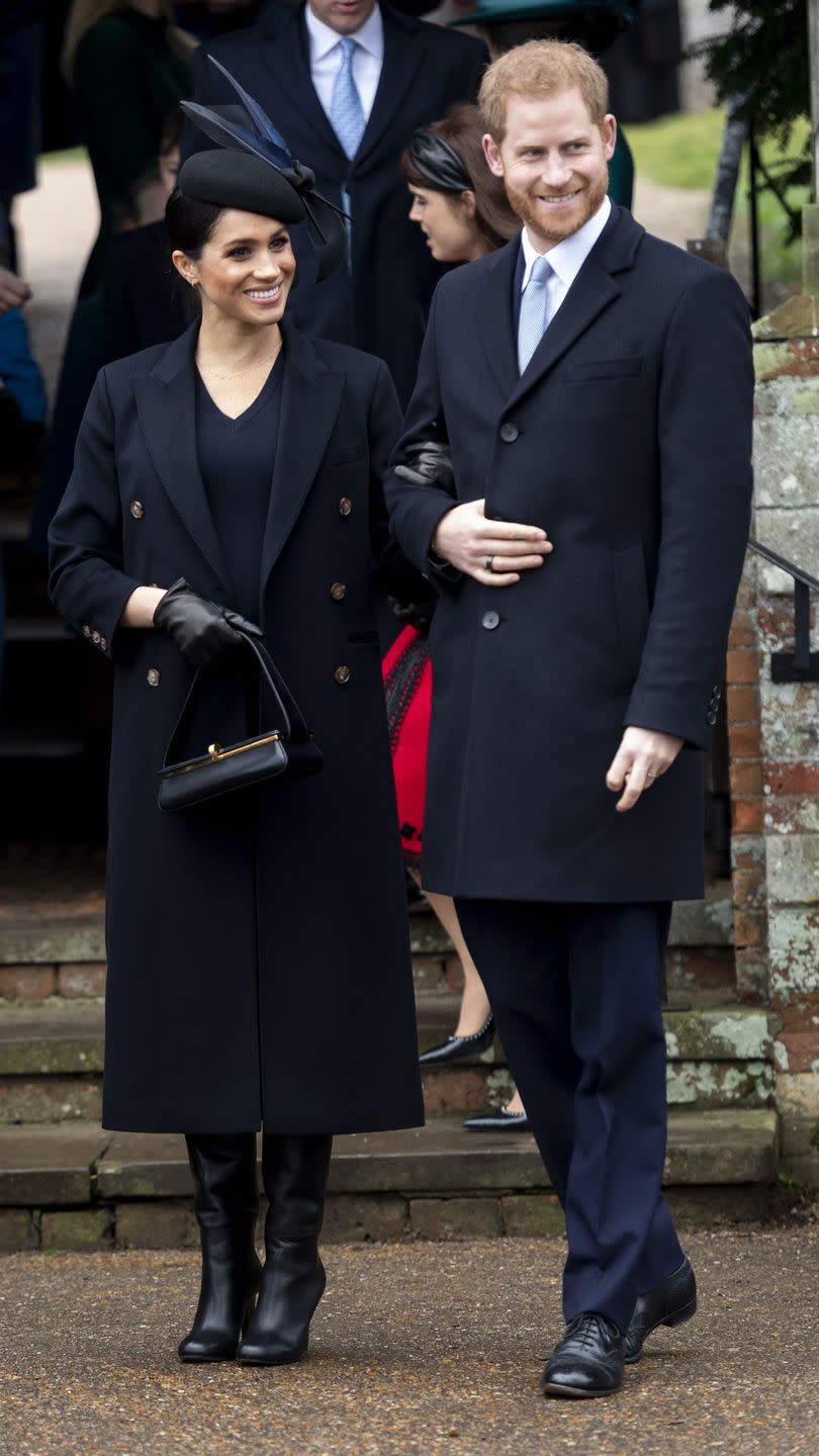 <p>Meghan Markle paired a navy dress and coat by Victoria Beckham with a feathered fascinator for the Christmas Day Church service in Sandringham. </p>