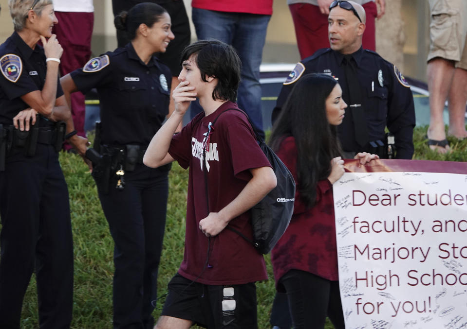 <p>A returning student reacts as he walks to Marjory Stoneman Douglas High School in Parkland, Fla., Wednesday, Feb. 28, 2018. Uniformed officers marched into Marjory Stoneman Douglas High School early Wednesday, just one aspect of the heavy security as classes resumed for the first time since students and teachers were killed by a troubled teenager with an AR-15, thrusting them into the center of the nation’s gun debate. (Joe Cavaretta/South Florida Sun-Sentinel via AP) </p>