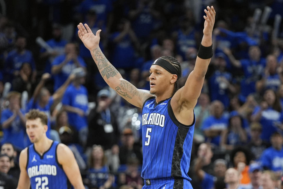 Orlando Magic forward Paolo Banchero (5) waves his arms to the fans to cheer during the second half of Game 4 of an NBA basketball first-round playoff series against the Cleveland Cavaliers, Saturday, April 27, 2024, in Orlando, Fla. (AP Photo/John Raoux)