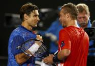 Spain's David Ferrer (L) talks with Australia's Lleyton Hewitt at the net after Ferrer won their second round match at the Australian Open tennis tournament at Melbourne Park, Australia, January 21, 2016. REUTERS/Thomas Peter