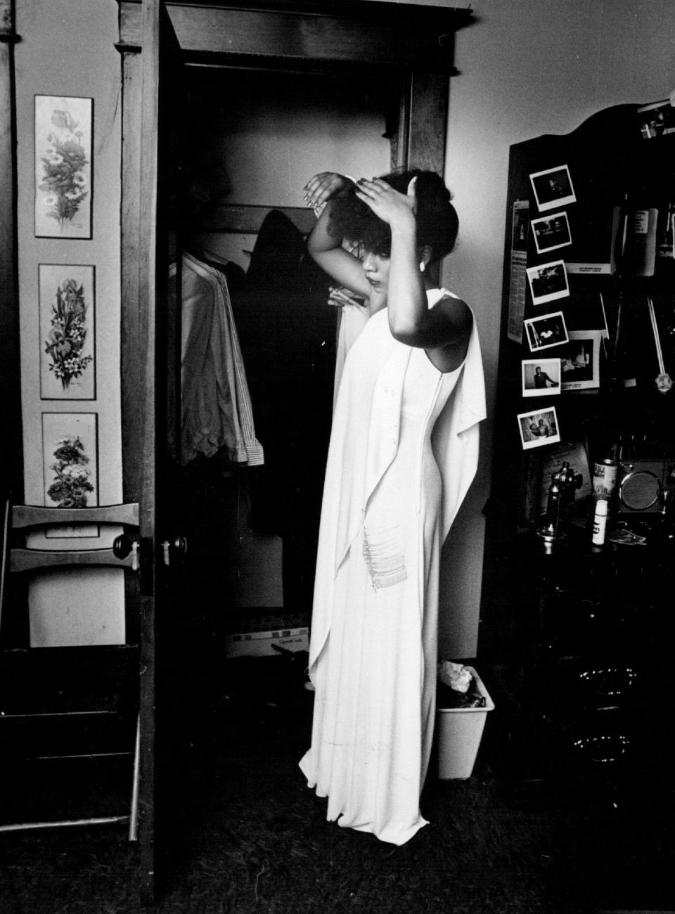 Stephanie Thomas puts finishing touches on her hair in preparation for her senior prom in 1980