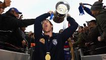 Injured Bulldogs skipper Robert Murphy celebrates with the AFL premiership trophy. Pic: Getty
