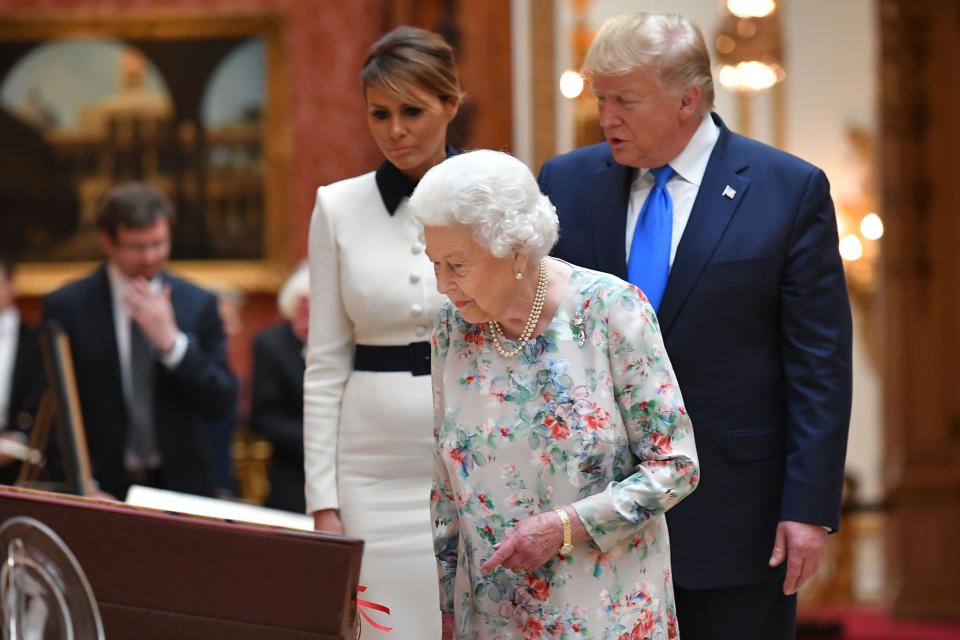 Queen Elizabeth II takes in a display of U.S. items of the Royal collection with President Trump and first lady Melania at Buckingham Palace on June 3, 2019.