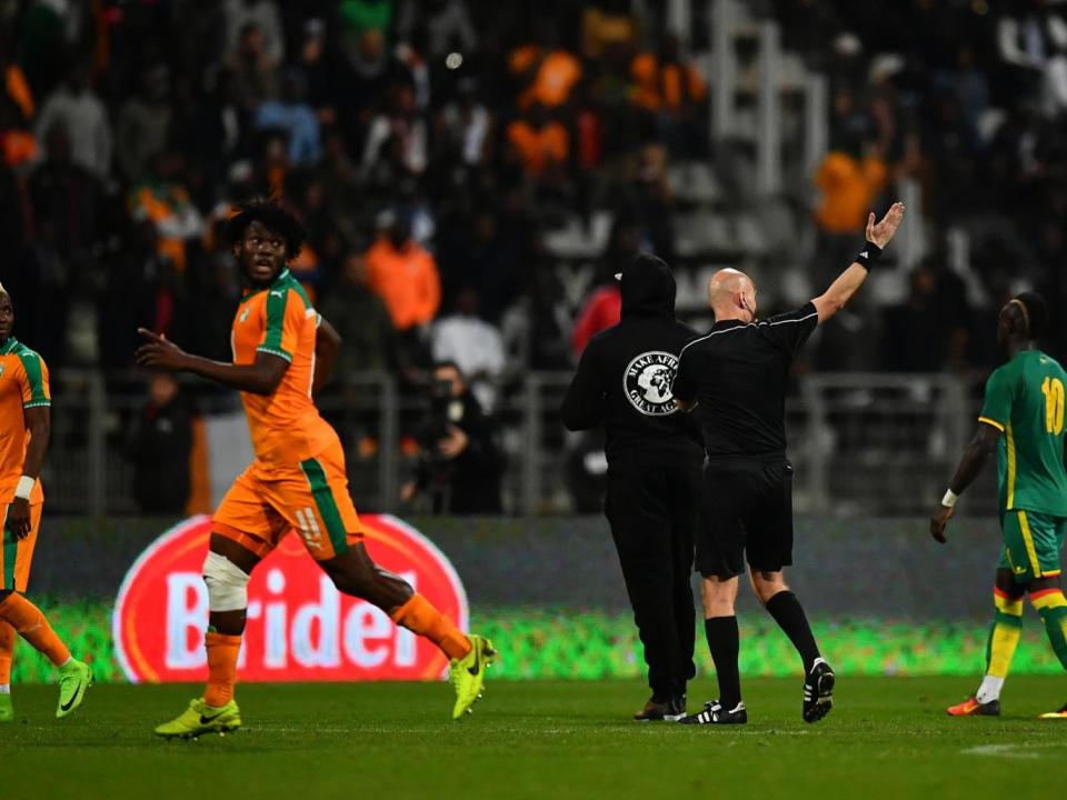 The players were forced to run away from several pitch invaders (Getty)