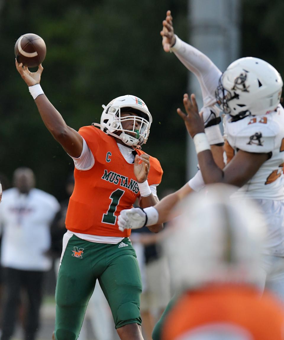 Mandarin quarterback Tramell Jones (1) launches a pass under pressure against Atlantic Coast in a September game.