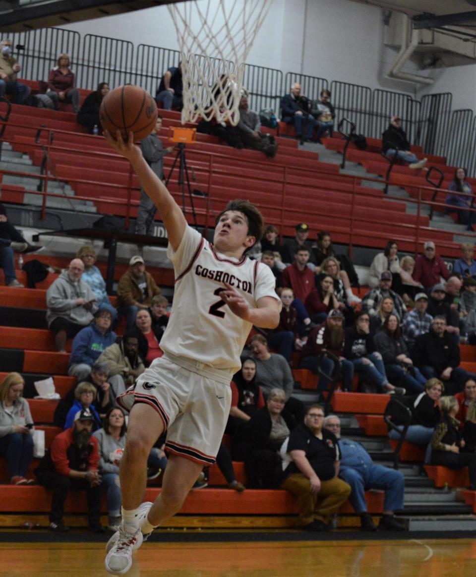 Coshocton's Colton Conkle lays the ball in after a turnover during a game against John Glenn earlier this season. Conkle made the Division III first team in District 5, as those teams were recently released.