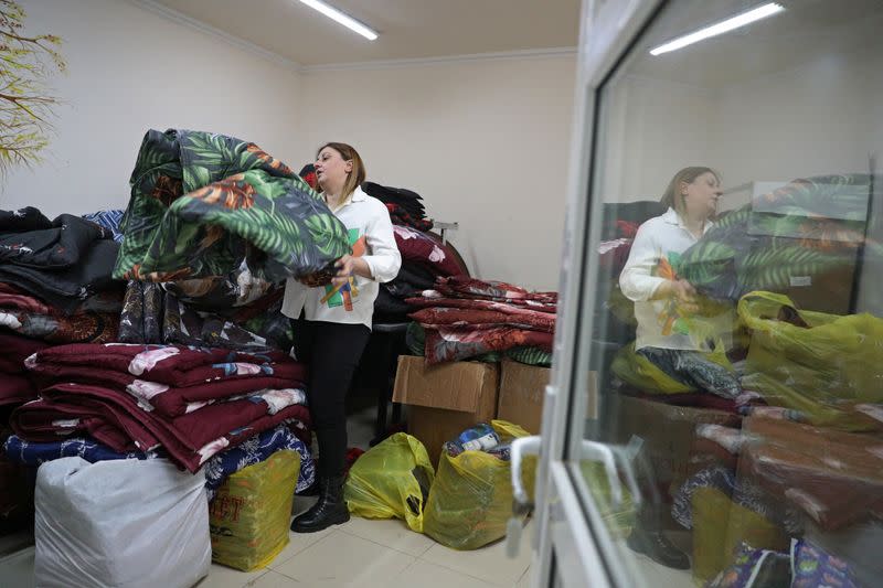 Charity worker Lilia Abrahamian shows blankets prepared for refugees from Nagorno-Karabakh region in Vanadzor