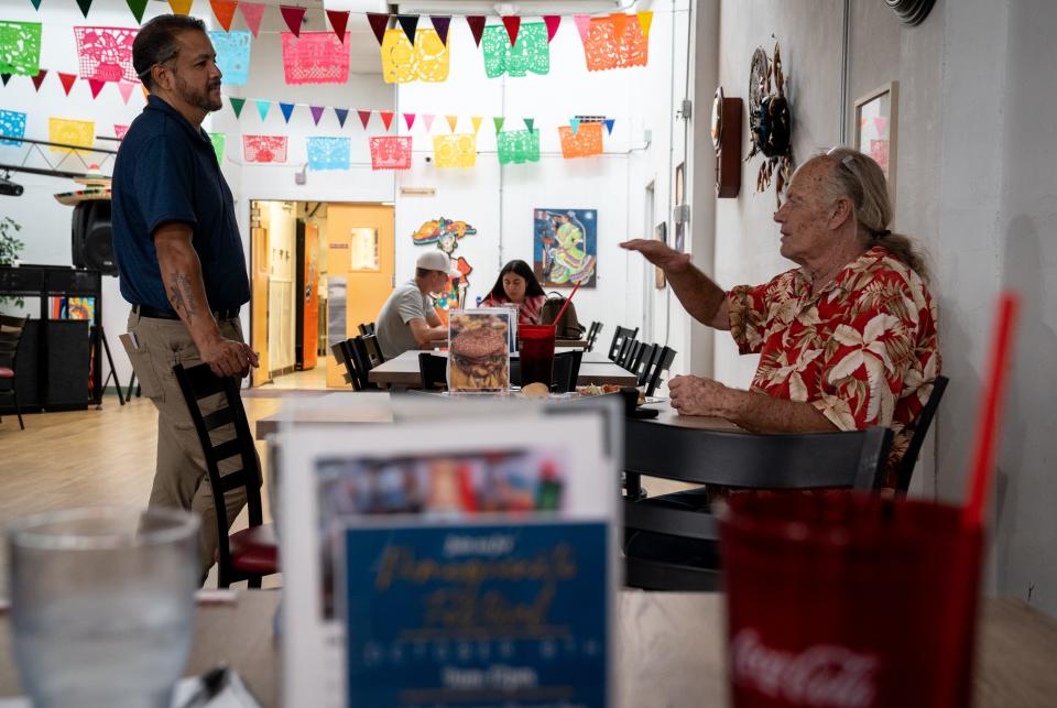 Sergio Hernandez (left, owner) talks with Mark Lee, September 22, 2022, at Tacos El Tarasco in Ajo, Arizona.