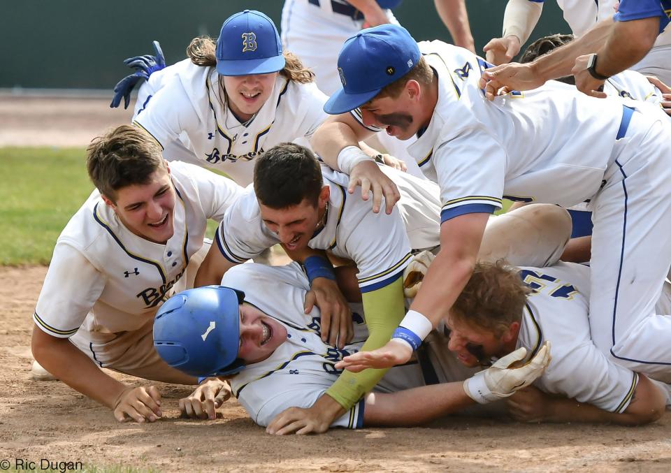Clear Spring's Dawson Kehr is mobbed by teammates at home plate after he hit a walk-off home run to beat Colonel Richardson 3-2 in 11 innings in the Maryland Class 1A baseball championship game Saturday at Regency Furniture Stadium in Waldorf.