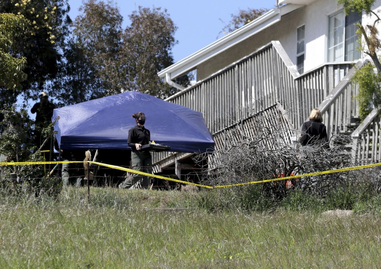 San Luis Obispo Sheriff's Office personnel continue their investigation while searching in the backyard of the home of Ruben Flores on March 16, 2021, in Arroyo Grande, Calif. 