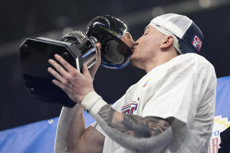 Arizona safety Gunner Maldonado kisses his trophy after he was named defensive player of the game in the Alamo Bowl NCAA college football game against Oklahoma in San Antonio, Thursday, Dec. 28, 2023. (AP Photo/Eric Gay)