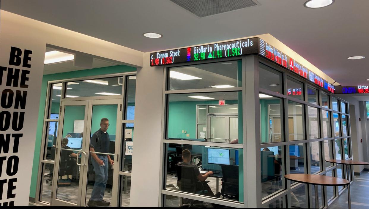 A stock ticker displays company prices outside a classroom at Jacksonville University's STEAM Institute designed for learning technology of  financial services and and geographic information.